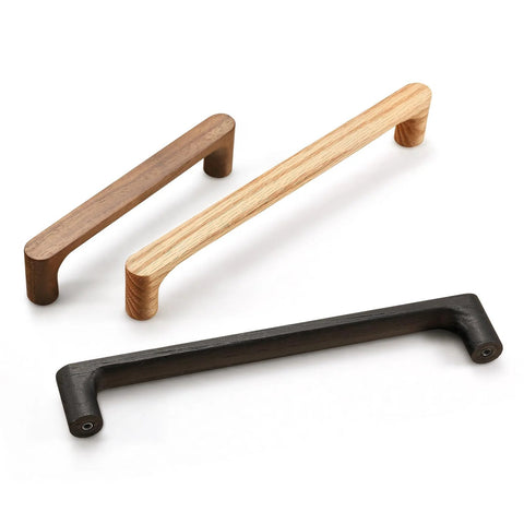 Three wooden cabinet handles in walnut, oak, and black finishes, showcasing minimalist design for kitchen doors and cabinets.