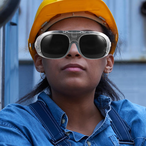 Boss Grade Welding Protective Glasses With Flexible Splash Visor And Full Spectrum Dust Control Black Gray Optical Lens Rugged Safety Goggles For Tradesmen worn by a worker under a helmet