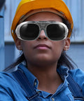 Badass Welding Goggles With Anti Splash Tinted Lenses For Arc Jobs And Shop Tasks shown on worker in denim shirt and hard hat.