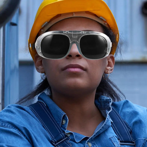 Top Shelf Welding Safety Goggles With Dustproof Anti Splash Shield And Dark Tinted Lenses Designed For Gritty Shop Floors Where Badass Eye Protection Never Slacks Off, worn by a worker.