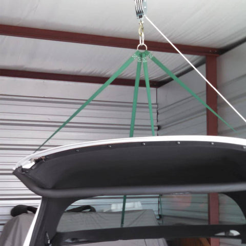 Rope Hoist 50 Ft 5 To 1 Block And Tackle Pulley System lifting a car roof in a garage with green straps and zinc-plated hooks