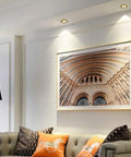 Top Shelf 14 Pack Recessed Led Ceiling Lights With Three Color Dimming And Slick Copper Trim For Modern Living Rooms Energy Saving Ambient Glow Quick Install Solid Home Fixtures illuminating artwork above couch.