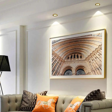 Top Shelf 14 Pack Recessed Led Ceiling Lights With Three Color Dimming And Slick Copper Trim For Modern Living Rooms Energy Saving Ambient Glow Quick Install Solid Home Fixtures illuminating artwork above couch.
