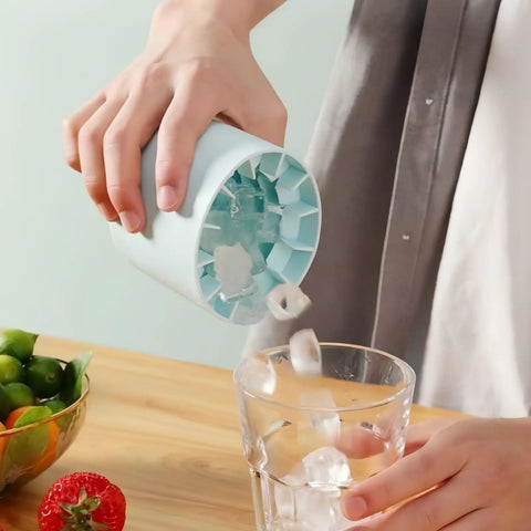 Person using 3D Upgraded Silicone Ice Cube Tray With Easy Release For Fast Ice 30 Cubes, Leak Proof And Space Saving Freezer Organizer, BPA Free, Ideal For Cocktails Coffee RV Office Parties Includes Travel Ice Bucket Blue to pour ice cubes into a glass