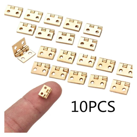 Rotating Concealed Hinges For Cabinets And Wooden Boxes, Brass Plated Mini Hinges 10 Pcs shown on a finger for size comparison.