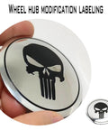 Four Piece Heavy Duty Aluminum Hub Center Cap Decals Featuring Dope Tusked Skull Art For Clean Wheel Cover Stickers That Slap Onto Most Standard Rims Smoothly, close-up of black skull design.