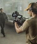 Filmmaker using Ronin 4 Axis Cinema Camera 8K Combo Kit With DL PZ 17 To 28mm T3 ASPH Lens in industrial setting