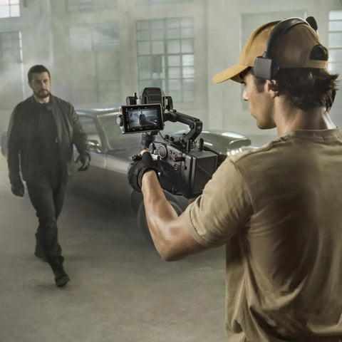Filmmaker using Ronin 4 Axis Cinema Camera 8K Combo Kit With DL PZ 17 To 28mm T3 ASPH Lens in industrial setting