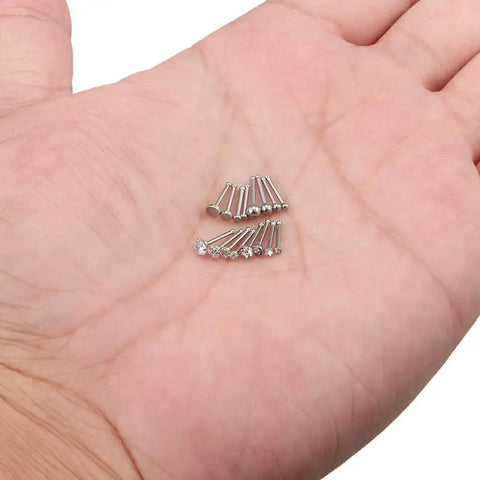 Sixteen Piece Nose Piercing Kit In 18G Surgical Steel With Top Flat, Top Ball, Clear Round CZ And Jeweled CZ Styles In 1.5mm, 2mm, 2.5mm, And 3mm Sizes, 6.5mm Pin Length, Ideal Nose Studs And Rings For Everyday Wear. 18G surgical steel nose studs on hand