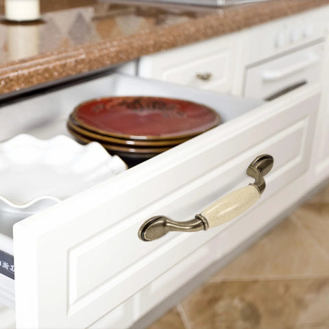 Open kitchen drawer showing Eight Piece Ceramic Drawer Handles Set In Chinese Style With Vintage Antique Design for cabinets.