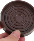 Person holding Round Rubber Furniture Coasters Non Slip Feet Pads For Tables And Chairs Easy To Install Noise Reducing Protector Cups