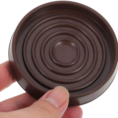 Person holding Round Rubber Furniture Coasters Non Slip Feet Pads For Tables And Chairs Easy To Install Noise Reducing Protector Cups