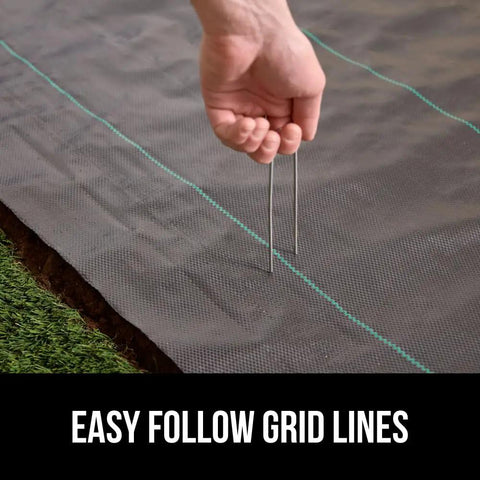 Heavy Duty Tough As Nails Weed Barrier Fabric 3 Ft By 50 Ft Ground Cover For Garden Beds And Mulch being installed
