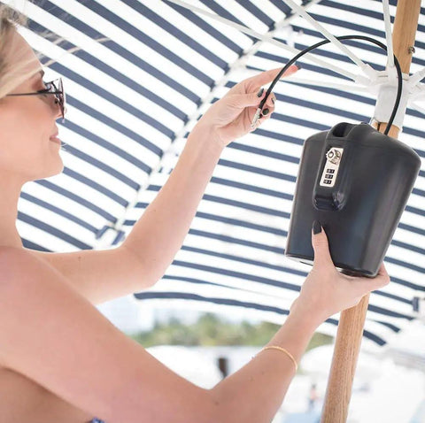 Portable Indoor Outdoor Lock Box Safe With Key And Combination Access Heavy Duty Steel Cable in use on a beach umbrella.