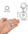 Top Shelf 30 Pc Lobster Clasp Keychain Set With Hella Strong Swivel Hooks Plus 100 Open Jump Rings For Diy Jewelry Making And Craft Repair. Hand holding a lobster claw keychain with a jump ring.