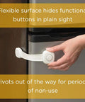 Hand adjusting Outsmart All-Purpose Multi-Use Strap Four Pack White Kidproof Locking Straps on cabinet door