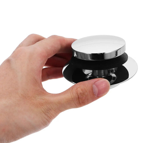 Universal Bathtub Drain Stopper Press Plug with Copper Core held in hand, shiny chrome finish, suitable for bathtub drainage.