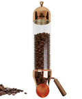 Solid Wall Mounted Coffee Bean Dispenser With No Sweat Sliding Dial And See Through Borosilicate Glass Cylinder showing coffee beans in a sleek design.