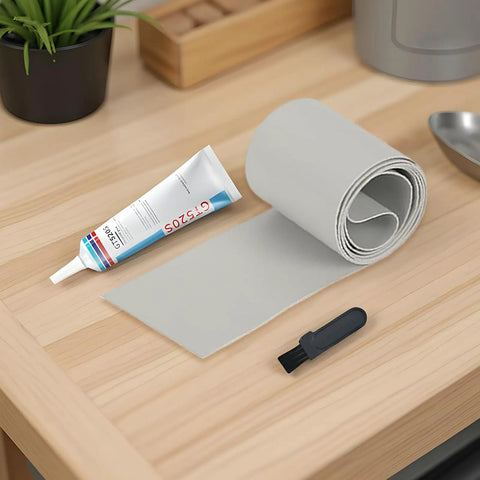 Inflatable Patch Repair Kit With Waterproof Tape And Heavy Duty Adhesive Seal Technology tube, tape roll, and brush on table