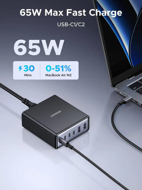 Six Port GaN Desktop Charger With 100W USB C Power Hub For MacBook Pro Air iPad iPhone Galaxy Pixel Dell XPS And More Fast Charge All Your Devices At Once shown charging a laptop, close-up view.