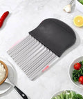Crinkle cutter with stainless steel blades and black plastic handle; kitchen potato and carrot slicer.