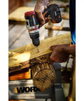 Using a Brushless Cordless Hammer Drill With Two 20 Volt Batteries And Active Hammer Action for wood drilling.