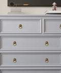 4 Pack Solid Antique Brass Cabinet Ring Pulls Set For Drawers And Cabinets 2 Inch Length installed on light gray dresser