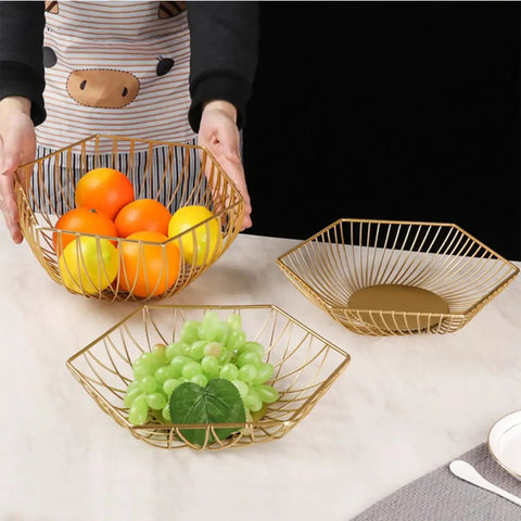 Golden Iron Fruit Basket For Fruits And Vegetables With Draining Water Feature And Geometric Wire Design displayed on table