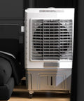 Portable Evaporative Air Cooler With Ice Packs And Water Tank, Three In One Swamp Cooling Unit For Room Or Office, Whisper Quiet Design is near a bed.