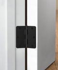 Matte Black Interior Door Hinges 3.5 Inch With Quarter Inch Radius Corners, installed on a white door frame, side view.