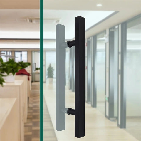 Beefy Black Stainless Steel Door Hardware Set With Square Tube Handle for glass doors, seen from side in office setting