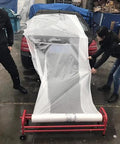 Rolling Masking Film Machine With Mobile Stand On Wheels For Car Paint Repair And Body Shop Easy On Site Masking Paper System For Painters And Pros Everywhere in use with car in background