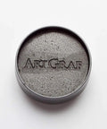 Water Soluble Graphite In A 20g Grey Tin For Wet Or Dry Sketching, portable artist grade graphite shown in a round tin.