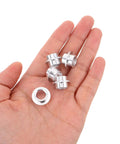Hand holding silver Rad High Quality Pro Grade Aluminum Skateboard Bearing Spacers Hardware Kit 30 Pcs self-centering axle spacers