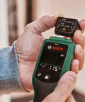 Hands holding Wood Moisture Meter With Pin Probes, Fast Reading For DIYers And Pros, Two Wood Groups, LED Traffic Light Indicator.