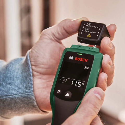 Hands holding Wood Moisture Meter With Pin Probes, Fast Reading For DIYers And Pros, Two Wood Groups, LED Traffic Light Indicator.