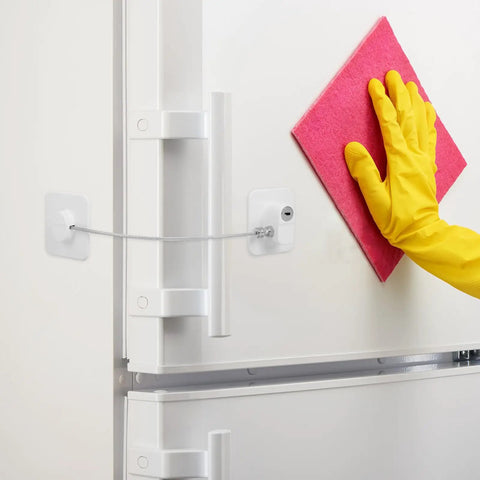 2 Pack Childproof Safety Locks For Refrigerator, Cabinets And Windows shown installed on a fridge with a yellow-gloved hand.