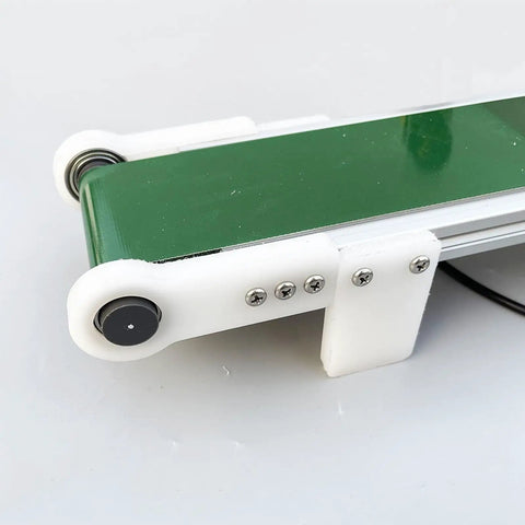 Close-up of Plug And Play Mini Electric Belt Conveyor For Desktop Use With PVC Belt, compact with visible screws and frame