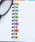Heavy Duty Hole Punch Reinforcement Stickers Six Sheets For Loose Leaf Paper Fixes That Patch Broken Ring Bindings And Keep Your Class Notes Intact With No Sweat This Semester on a notebook with colorful rings.