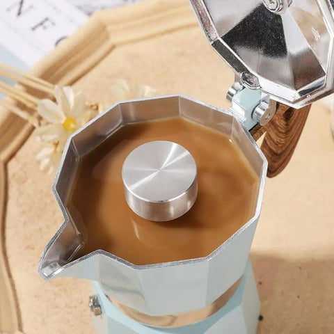 Moka Pot Guard Stainless Steel Spray Cap Anti Splash Shield for Moka Coffee Pot shown on hexagonal pot, open lid with coffee inside.