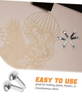 100 Pcs Iron Brads For Paper Crafting And Puppet Making Kit Double Leg Fasteners shown alongside cut paper artwork