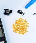 100 Pack Miniature Plastic Bushings and Axle Sleeves for Toy Vehicles with orange sleeves on a white background.