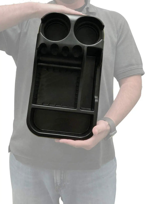 Person holding Must Have Ride Universal Floor Console Organizer For Cars Trucks And Minivans Black ABS Vinyl Clutter Catcher