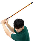 Person using Golf Swing Trainer Pro Indoor Practice Aid With MAX SPEED Stick for timing and impact improvement.