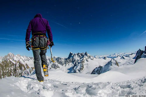 Hiker with Ski Tour New-Matic Crampons for Ski Touring with Ultra Lightweight, Bomb Proof Front Bail on snowy mountain summit