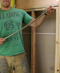 Man demonstrating Rack-A-Tiers Pipe Viper Cold Bend Tool for Half Inch Schedule 40 PVC Conduit Bender.