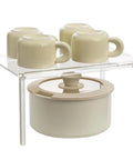 Clear Acrylic Cabinet Organizer And Kitchen Countertop Spice Rack slick multi tier shelf riser with beige cups and pot.