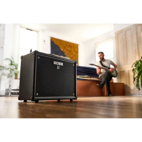 Katana 50 Gen 3 Guitar Amp Compact 50-Watt Combo With 12-Inch Speaker, in living room with guitarist in background