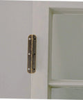 Brass piano hinge installed on white door, edge view