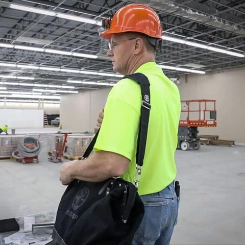 Person wearing a Padded Adjustable Shoulder Strap For Tool Tote And 5003 Series Bags, 37 To 55 Inch, on a construction site.